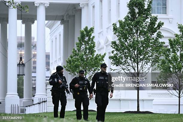 Secret Service agents are seen after a lockdown was lifted at the White House in Washington, DC, on May 23, 2026. Police and security forces swarmed...