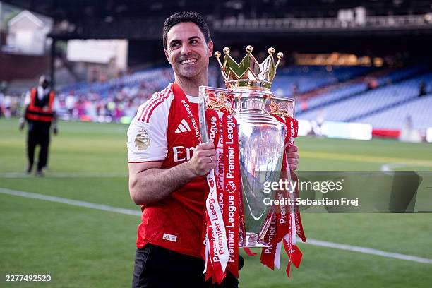 Mikel Arteta, manager of Arsenal celebrates with a the Premier League trophy during the Premier League match between Crystal Palace and Arsenal at...