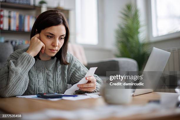 concerned woman reviewing bills and expenses - rejection stock pictures, royalty-free photos & images