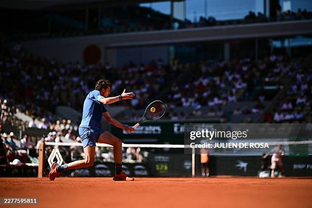 France's Ugo Humbert plays a backhand return to France's Adrian Mannarino during their men's singles match on day 2 of the French Open tennis...