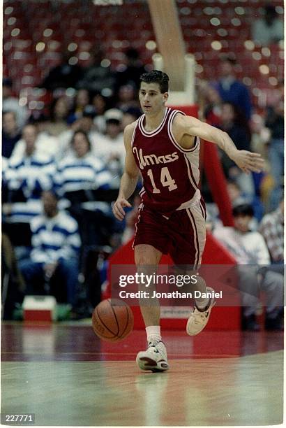 UNIVERSITY OF MASSACHUSETTS MINUTEMEN GUARD DEREK KELLOGG DRIBBLES THE BALL DOWN COURT DURING A NON-CONFERENCE GAME WITH THE DEPAUL BLUE DEMONS.