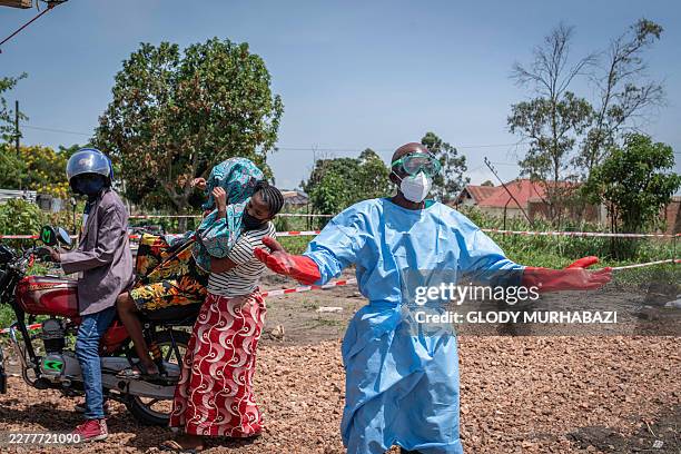 Dieudonné Sezabo , a health worker, gestures as he asks for help in transporting a patient suspected of having Ebola, who was brought by motorcycle...