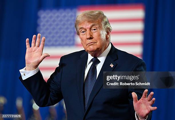 President Donald Trump dances on stage after delivering remarks during a campaign and economic policy event in the Eugene Levy Fieldhouse at SUNY...