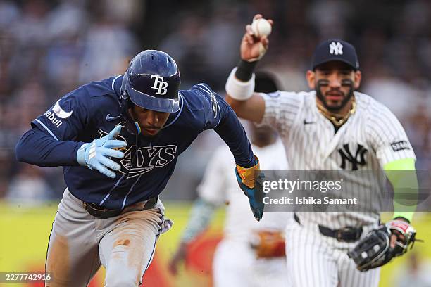 Chandler Simpson of the Tampa Bay Rays runs while being chased by José Caballero of the New York Yankees during the first inning at Yankee Stadium on...