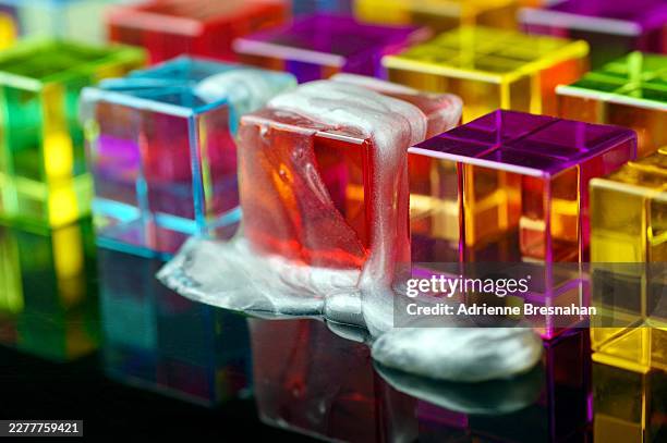 metallic silver slime encasing transparent acrylic cube within colorful geometric network - perspex cube stock pictures, royalty-free photos & images