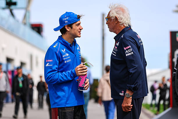Franco Colapinto of Argentina and Alpine F1 Team talks with Alpine Team Principal Flavio Briatore in the paddock during the Sprint Race ahead of the...