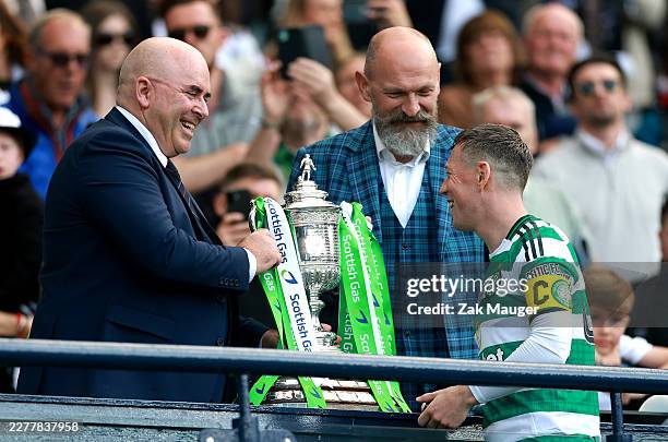 Callum McGregor of Celtic receives the Scottish Gas Scottish Cup Trophy from Mike Mulraney, President of the Scottish FA, after his team’s victory in...