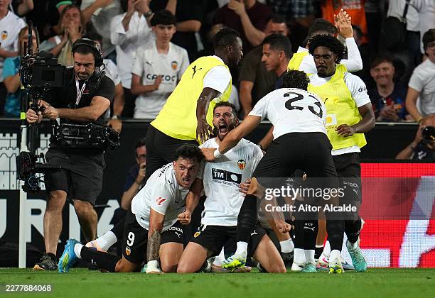 Luis Rioja of Valencia CF celebrates scoring his team's second goal with teammates during the LaLiga EA Sports match between Valencia CF and FC...