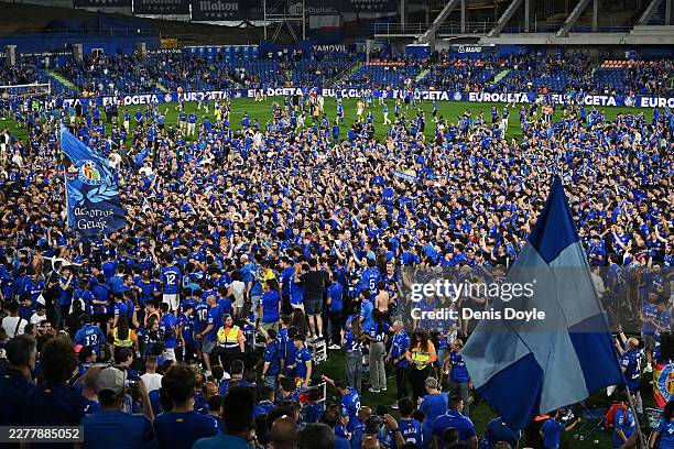 Fans of Getafe CF celebrate on the pitch after their victory during the LaLiga EA Sports match between Getafe CF and CA Osasuna at Coliseum Alfonso...