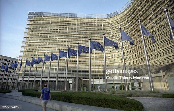 Flags are seen in front of the Berlaymont, the EU Commission headquarter on May 24, 2026 in Brussels, Belgium. The Berlaymont building serves as the...