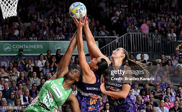 Ruby Bakewell-Doran of the Firebirds and Romelda Aiken-George of the Fever cftbduring the round 11 Super Netball match between Queensland Firebirds...