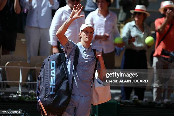 Italy's Jannik Sinner acknowledges the crowd as he reacts to his men's singles match defeat to Argentina's Juan Manuel Cerundolo on day 5 of the...