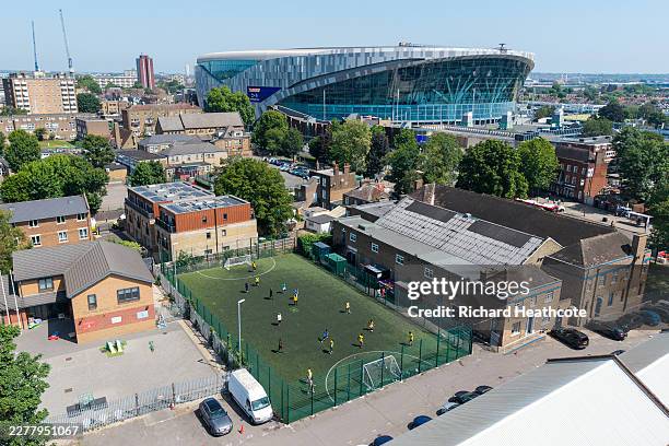 People play football on a 5-a-side pitch before the Premier League match between Tottenham Hotspur and Everton at Tottenham Hotspur Stadium on May...