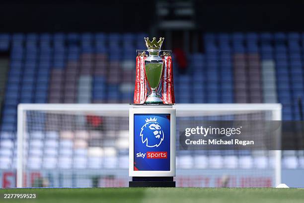 The Premier League trophy, dressed in red and white ribbons, is displayed on a Premier League Sky Sports branded plinth on the pitch prior to the...