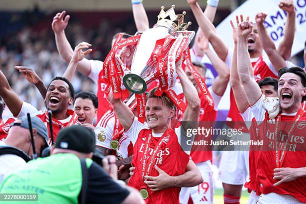 Martin Odegaard of Arsenal lifts the Premier League Trophy after their team's victory in the Premier League match between Crystal Palace and Arsenal...