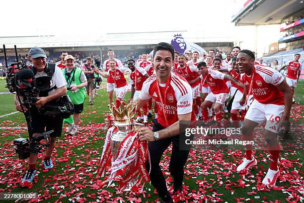 Mikel Arteta, Manager of Arsenal, celebrates with the Premier League trophy, as Arsenal are crowned the Champions of the Premier League for the...