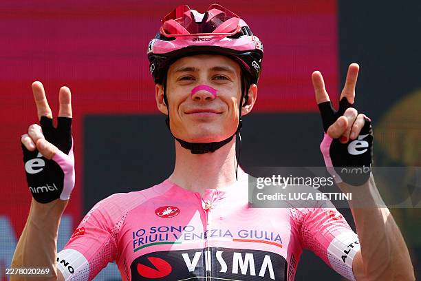 Team Visma Lease a Bike Danish rider Jonas Vingegaard wearing the overall leader's pink jersey looks on before the start of the 19th stage of the...