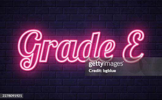 Grade E - Glowing neon text on brick wall background Grade E - Glowing neon text on brick wall background