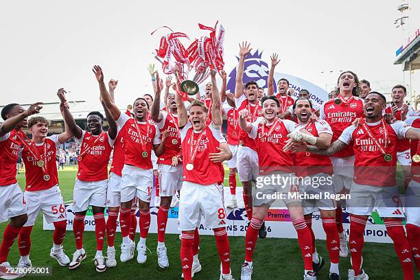 Martin Odegaard of Arsenal lifts the Premier League trophy during the Premier League match between Crystal Palace and Arsenal at Selhurst Park on May...