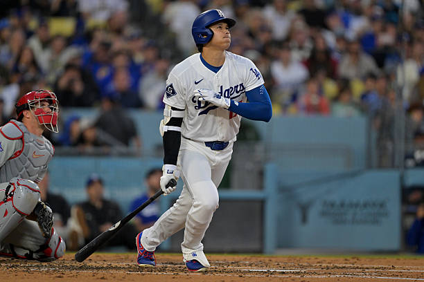 Shohei Ohtani of the Los Angeles Dodgers watches the flight of the ball on a solo home run in the third inning against the Philadelphia Phillies at...