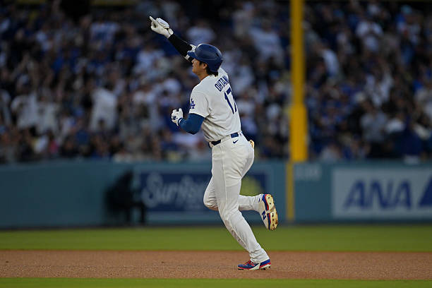 Shohei Ohtani of the Los Angeles Dodgers rounds the bases after hitting a solo home run in the third inning against the Philadelphia Phillies at...