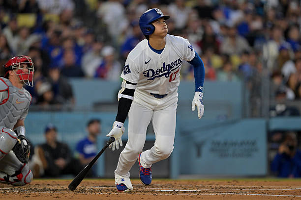 Shohei Ohtani of the Los Angeles Dodgers watches the flight of the ball on a solo home run in the third inning against the Philadelphia Phillies at...