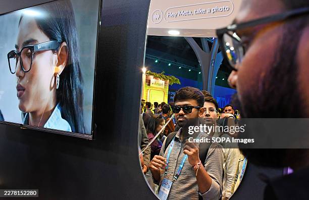 Visitor checks himself in the mirror after trying a Ray-Ban Meta glasses at a Meta stall at Mumbai Tech Week in Mumbai. Mumbai Tech Week is a...