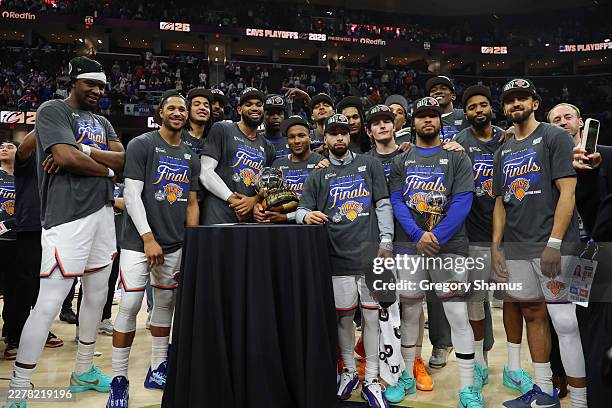 The New York Knicks celebrate with the Bob Cousy Trophy after defeating the Cleveland Cavaliers 130-93 in Game Four of the NBA Eastern Conference...