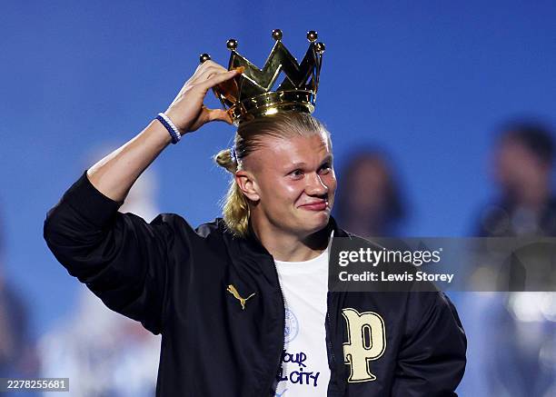 Erling Haaland of Manchester City puts the crown from the 2022/2023 Premier League trophy on his head after dropping it during the After Party...
