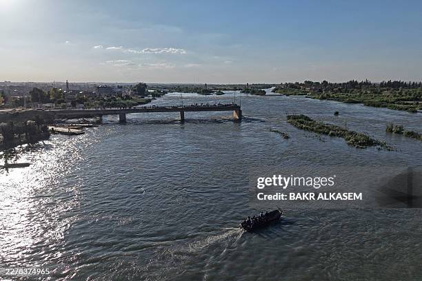 This aerial picture shows an inundated area in Raqa province following recent flooding as water levels rise along the Euphrates River on May 30,...