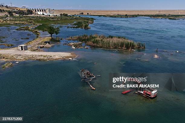 This aerial picture shows an inundated area as water is released from the Euphrates Dam in Tabqa in Raqa province as water levels rise along the...