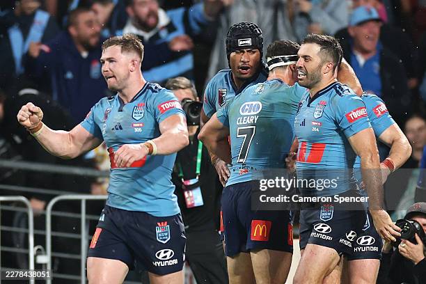 Ethan Strange of the Blues celebrates scoring a try during game one of the 2026 Men's State of Origin series between New South Wales Blues and...