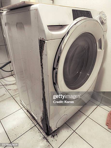 severely rusted front-loading washing machine with water damage - leaking washing machine stock pictures, royalty-free photos & images