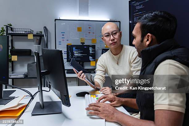 senior developer explaining code logic to junior programmer during office learning session. - programmer working stock pictures, royalty-free photos & images