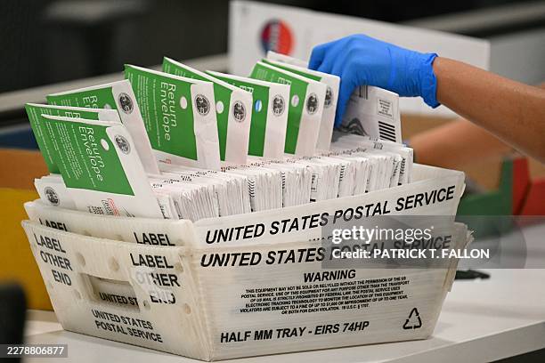 An election worker processes mail-in ballots at the Los Angeles County Ballot Processing Center during California's state primary election in the...