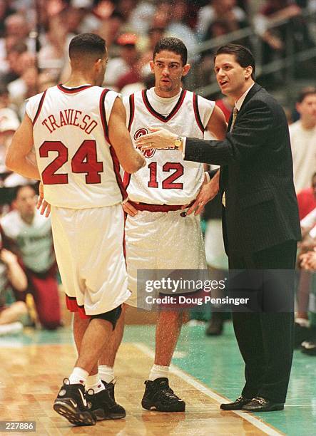 Head coach John Calipari of the UMass Minutemen talks with guards Edgar Padilla and Carmelo Travieso during the NCAA Final Four Semifinal game...