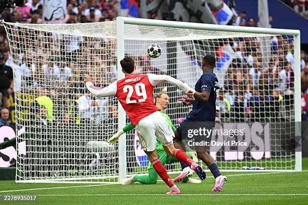 Kai Havertz of Arsenal scores his team's first goal whilst under pressure from William Pacho of Paris Saint-Germain as Matvey Safonov of Paris...