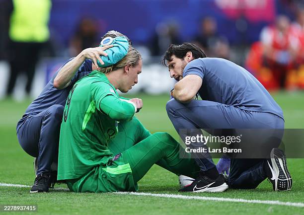 Matvey Safonov of Paris Saint-Germain receives medical treatment on the pitch during the UEFA Champions League Final 2026 match between Paris...