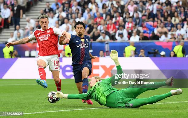 Matvey Safonov of Paris Saint-Germain makes a save against Leandro Trossard of Arsenal during the UEFA Champions League Final 2026 match between...
