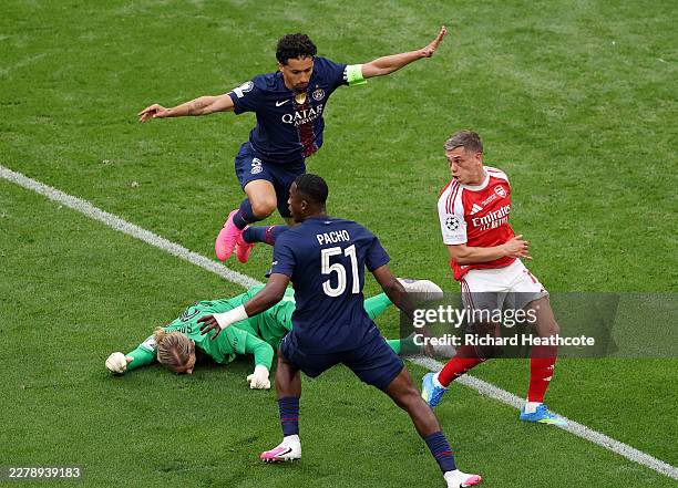 Matvey Safonov of Paris Saint-Germain lies on the floor as he reacts after challenging Leandro Trossard of Arsenal, before receiving medical...