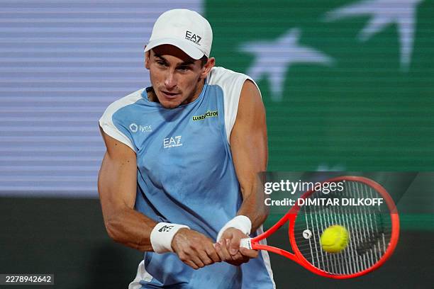 Italy's Matteo Arnaldi plays a backhand return to Italy's Matteo Berrettini during their men's quarter final singles match on day 11 of the French...