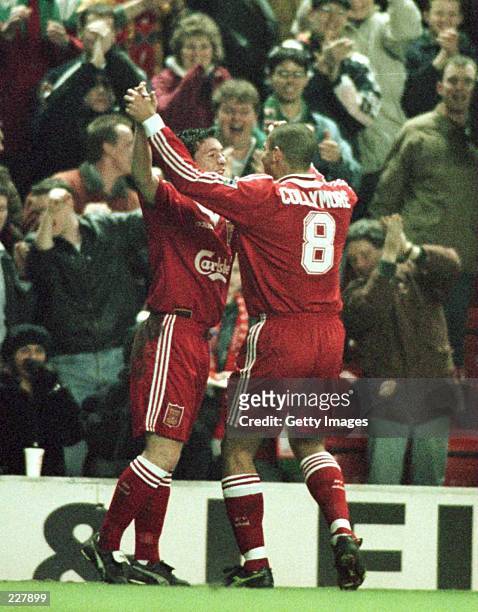 Stan Collymore of Liverpool celebrates with first goal scorer Robbie Fowler during Liverpool v Charlton Athletic in the FA cup fifth round at Anfield.