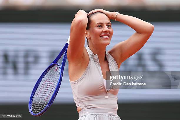 Marta Kostyuk of Ukraine celebrates winning match point against Iga Swiatek of Poland during their Women's Singles fourth round match on Day Eight of...