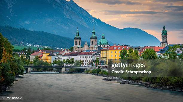 innsbruck austria old town skyline on inn river with alpine mountains at sunset - innsbruck stock pictures, royalty-free photos & images