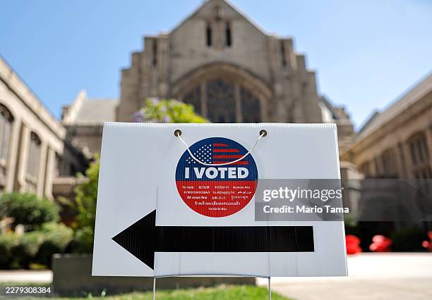 An "I Voted" sign points to a Vote Center ahead of tomorrow's primary election on June 1, 2026 in Pasadena, California. With just one day remaining...