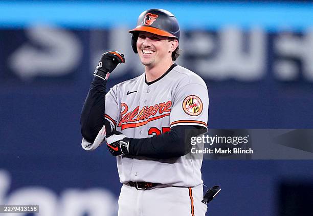 Adley Rutschman of the Baltimore Orioles celebrates his two-RBI double against the Toronto Blue Jays during the ninth inning of an MLB game at the...