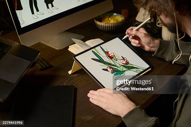 freelance graphic designer drawing on a graphics tablet at home - designer computer screen stock illustrations