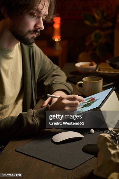 freelancer creating digital art on graphics tablet in home office - millennials working stock illustrations