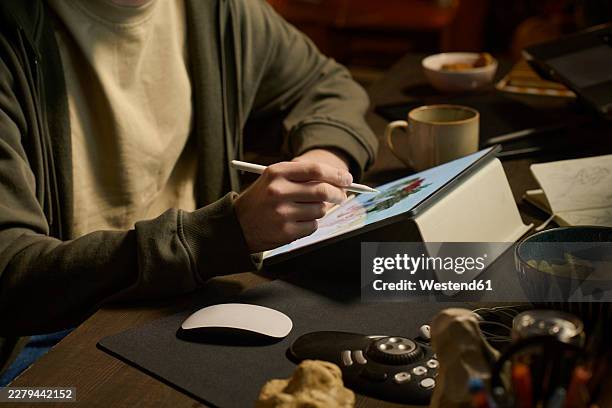 unrecognizable designer drawing on graphics tablet at home office - ipad on table stock illustrations