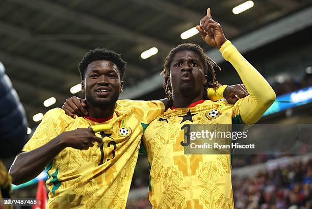 Caleb Yirenkyi of Ghana celebrates with team mate Christopher Baah after scoring the first goal during the international friendly match between Wales...
